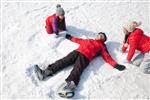 Three kids making snow angels