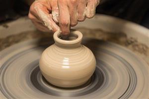 Pottery being shaped on a pottery wheel.